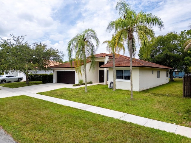 581 SW 169th Way, Weston, FL 33326 - view of front of property with a garage, concrete driveway, stucco siding, a tiled roof, and a front yard