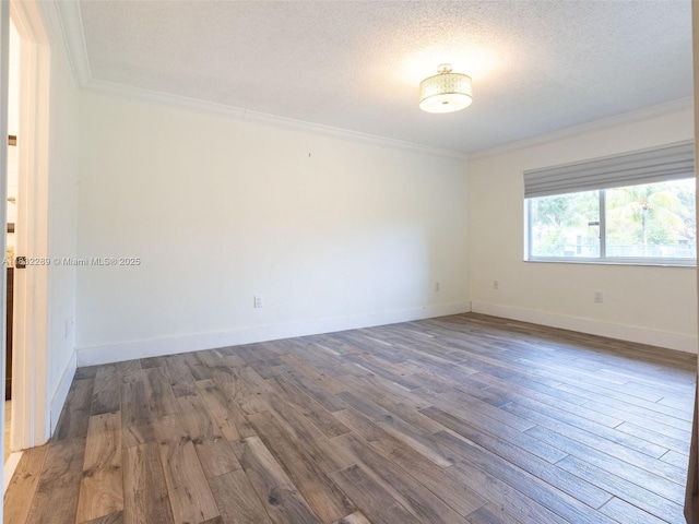 581 SW 169th Way, Weston, FL 33326 - spare room featuring ornamental molding, wood finished floors, and a textured ceiling