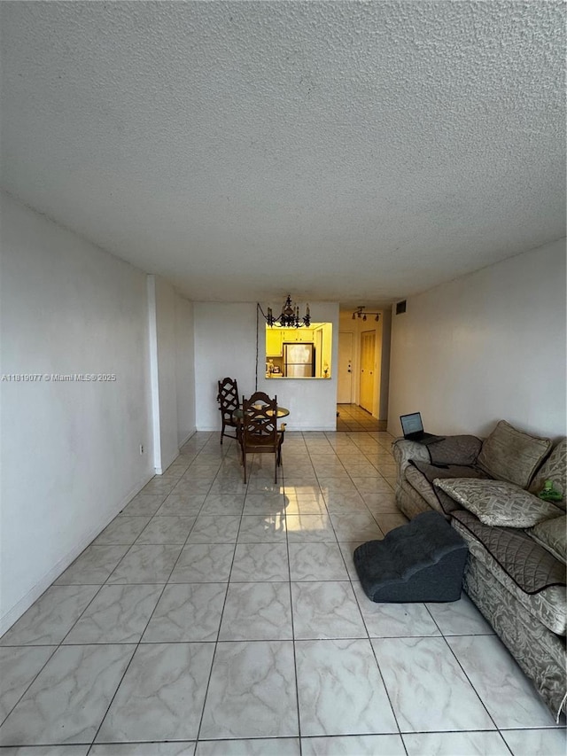 16851 NE 23rd Ave Unit A516, North Miami Beach, FL 33160 - living room featuring a textured ceiling