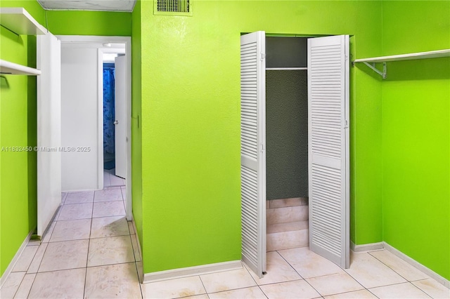 1755 W 60th St Unit D206, Hialeah, FL 33012 - unfurnished bedroom featuring a closet and light tile patterned floors