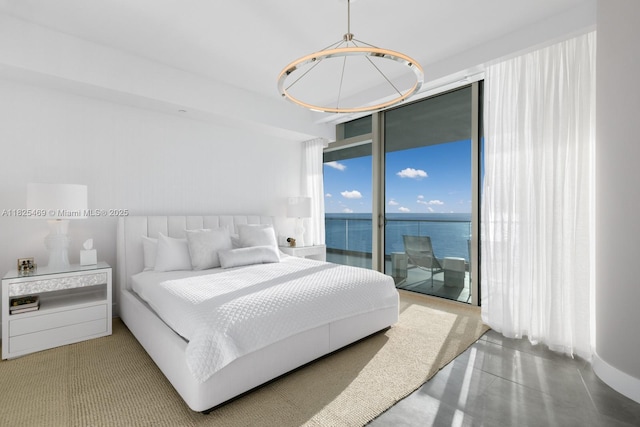 10203 Collins Ave Unit 1003, Bal Harbour, FL 33154 - bedroom featuring floor to ceiling windows, access to exterior, and a chandelier