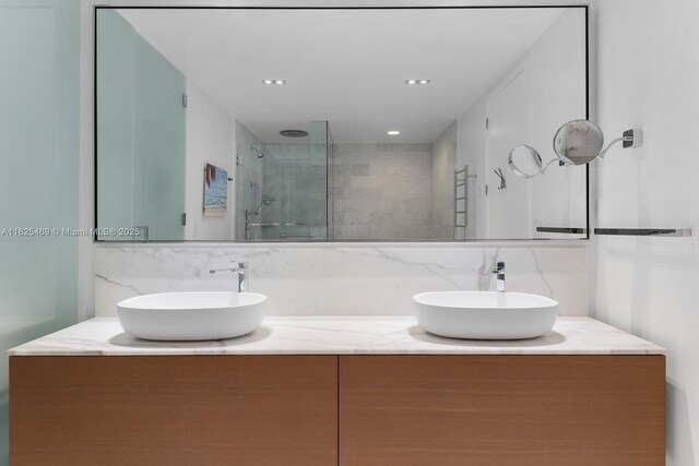 10203 Collins Ave Unit 1003, Bal Harbour, FL 33154 - full bathroom featuring decorative backsplash, double vanity, and a marble finish shower