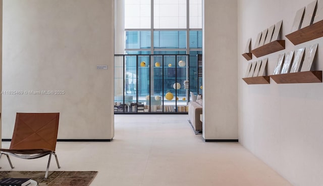 10203 Collins Ave Unit 1003, Bal Harbour, FL 33154 - corridor with a wall of windows and a high ceiling