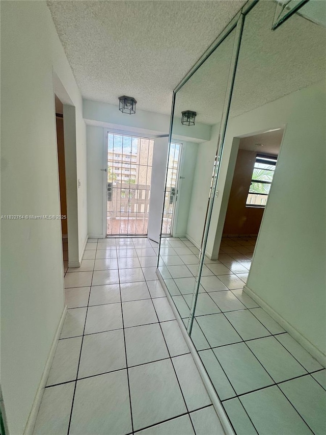 401 SE 3rd St Unit 405, Dania Beach, FL 33004 - spare room with a textured ceiling and light tile patterned floors
