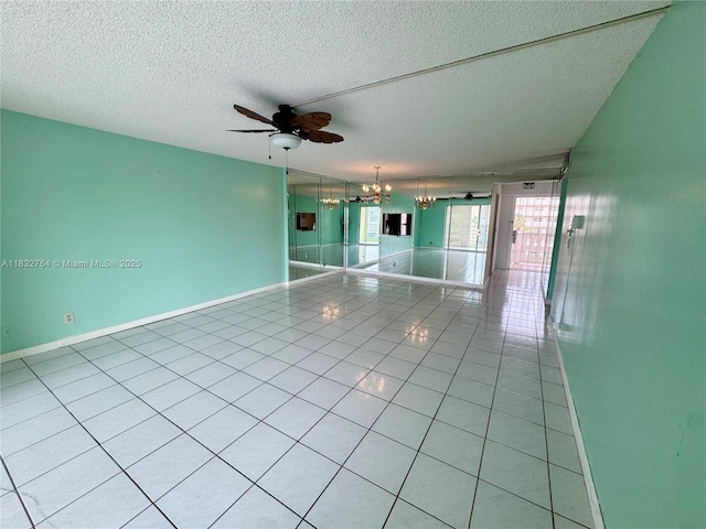 401 SE 3rd St Unit 405, Dania Beach, FL 33004 - spare room with a chandelier, ceiling fan, light tile patterned floors, and a textured ceiling