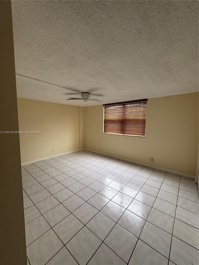 401 SE 3rd St Unit 405, Dania Beach, FL 33004 - unfurnished room featuring a textured ceiling, light tile patterned floors, and ceiling fan