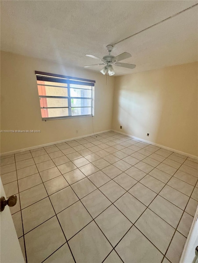 401 SE 3rd St Unit 405, Dania Beach, FL 33004 - empty room featuring light tile patterned floors, a ceiling fan, and a textured ceiling