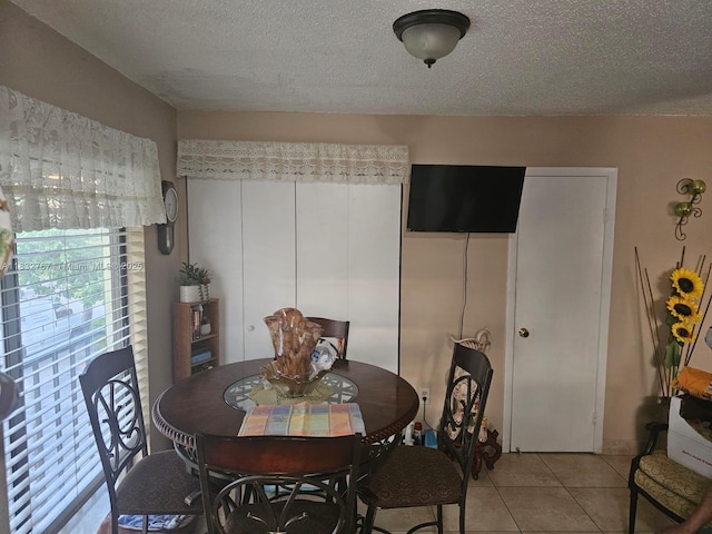 1521 W 42nd Pl Unit 18, Hialeah, FL 33012 - dining space featuring a textured ceiling and light tile patterned flooring