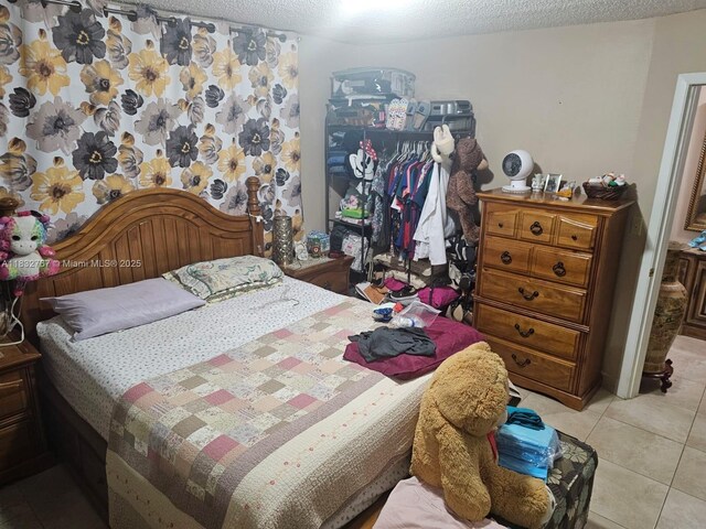 1521 W 42nd Pl Unit 18, Hialeah, FL 33012 - bedroom featuring light tile patterned floors and a textured ceiling