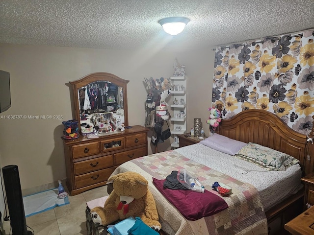 1521 W 42nd Pl Unit 18, Hialeah, FL 33012 - bedroom featuring a textured ceiling and light tile patterned flooring