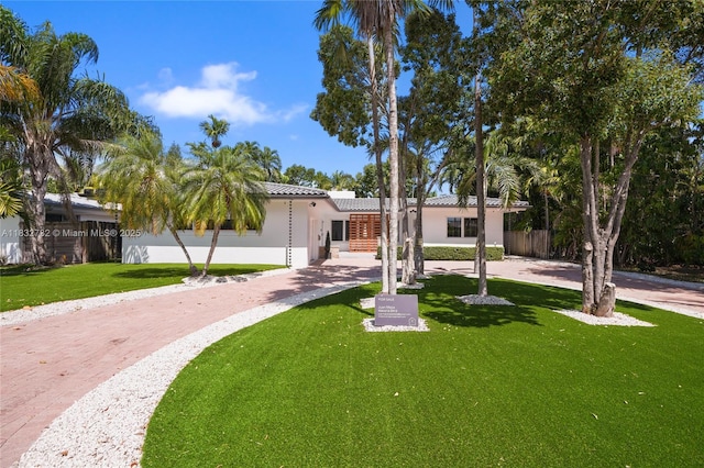 1221 NE 87th St, Miami, FL 33138 - view of front of property featuring a front lawn, stucco siding, driveway, and a tile roof