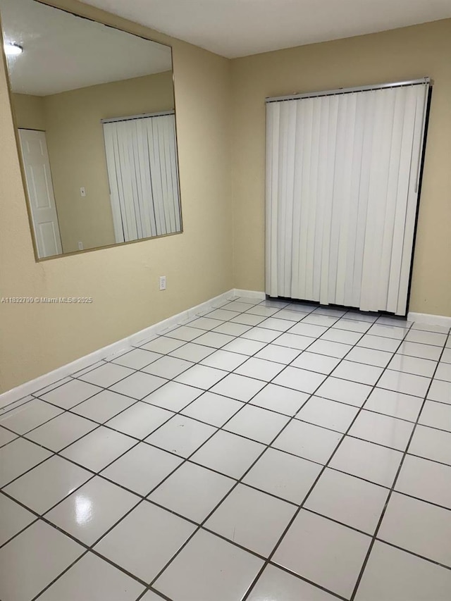 2341 W 66th Pl Unit 103, Hialeah, FL 33016 - unfurnished room featuring baseboards and light tile patterned flooring