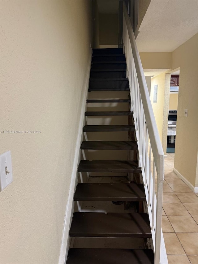 2341 W 66th Pl Unit 103, Hialeah, FL 33016 - stairway with tile patterned floors and a textured wall