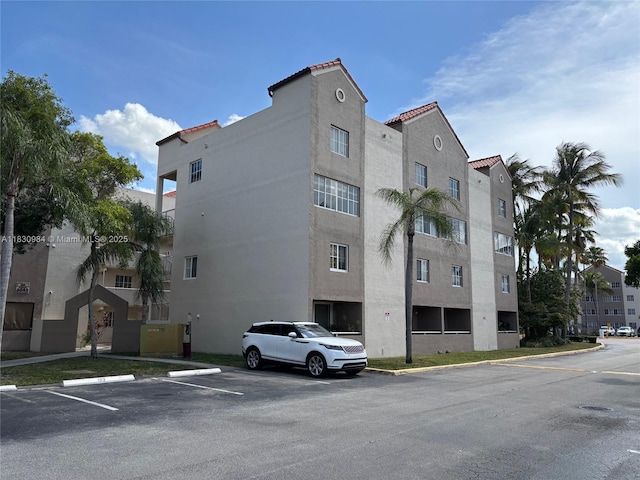 6045 NW 186th St Unit 103, Hialeah, FL 33015 - view of apartment building / complex with uncovered parking