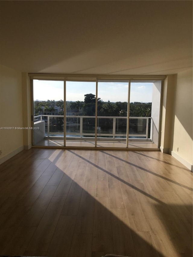 5700 Collins Ave Unit 6J, Miami Beach, FL 33140 - spare room featuring wood finished floors and floor to ceiling windows
