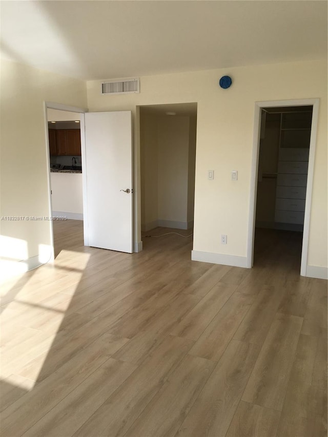 5700 Collins Ave Unit 6J, Miami Beach, FL 33140 - unfurnished bedroom with a spacious closet, wood finished floors, and a closet