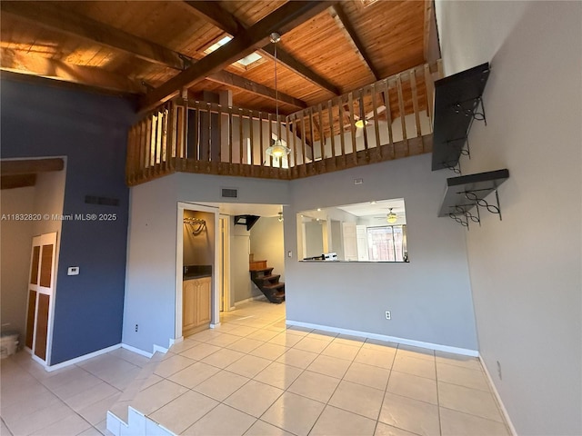 1965 SW 81st Way, Davie, FL 33324 - unfurnished living room featuring a wood ceiling with exposed beams, stairway, a ceiling fan, light tile patterned floors, and a high ceiling