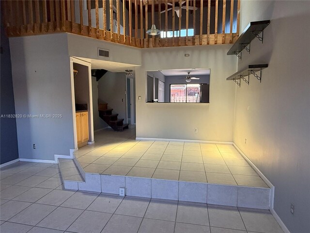 1965 SW 81st Way, Davie, FL 33324 - tiled empty room featuring a high ceiling, stairs, and ceiling fan