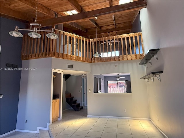 1965 SW 81st Way, Davie, FL 33324 - unfurnished living room featuring a high ceiling, a wooden ceiling with exposed beams, ceiling fan, stairs, and tile patterned floors
