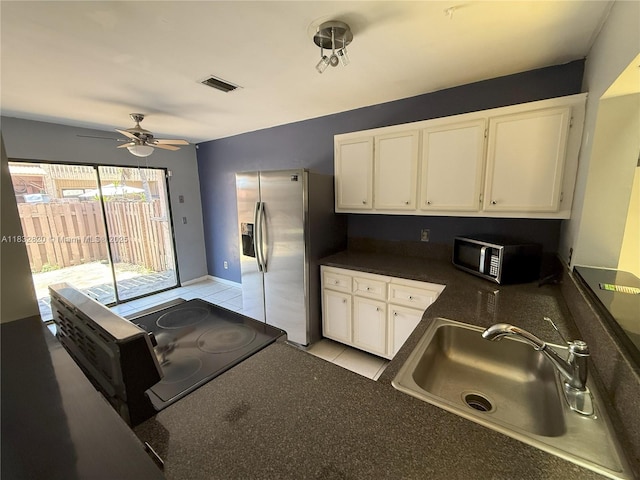 1965 SW 81st Way, Davie, FL 33324 - kitchen with stainless steel appliances, dark countertops, white cabinetry, a ceiling fan, and light tile patterned floors