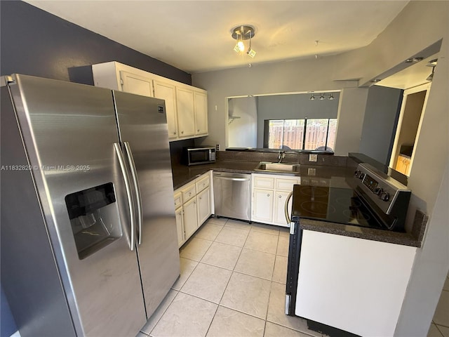 1965 SW 81st Way, Davie, FL 33324 - kitchen featuring stainless steel appliances, dark countertops, white cabinetry, and light tile patterned floors