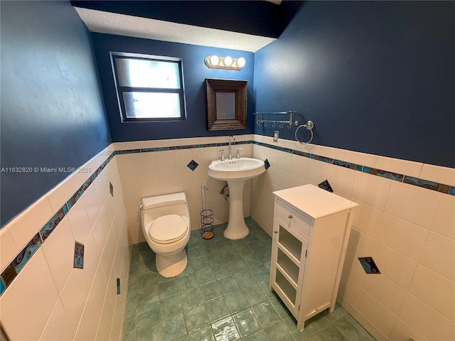 1965 SW 81st Way, Davie, FL 33324 - bathroom with tile walls, a wainscoted wall, and tile patterned floors