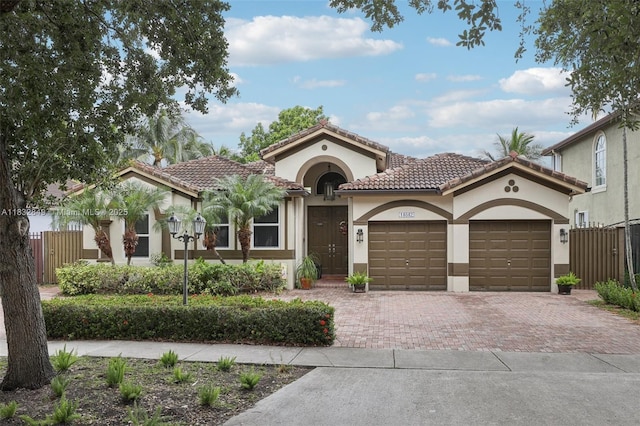 14842 SW 22nd Ter, Miami, FL 33185 - mediterranean / spanish home with decorative driveway, a garage, a tile roof, and stucco siding