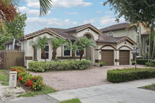 14842 SW 22nd Ter, Miami, FL 33185 - mediterranean / spanish-style house featuring stucco siding, a garage, a tiled roof, and driveway