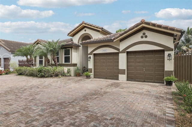 14842 SW 22nd Ter, Miami, FL 33185 - view of front of house with an attached garage, decorative driveway, stucco siding, and a tile roof