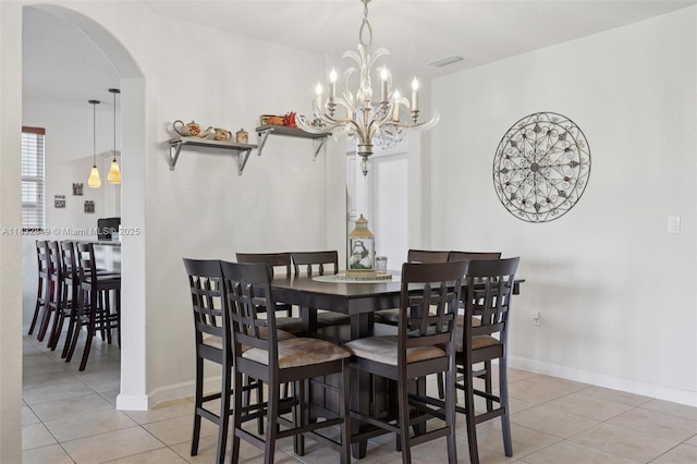 14842 SW 22nd Ter, Miami, FL 33185 - dining area featuring light tile patterned floors, arched walkways, and a chandelier