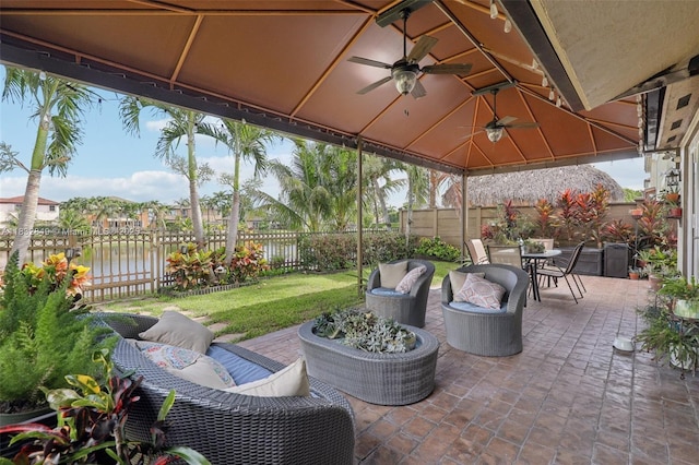 14842 SW 22nd Ter, Miami, FL 33185 - fenced backyard with a gazebo, a ceiling fan, outdoor dining space, a patio area, and a water view