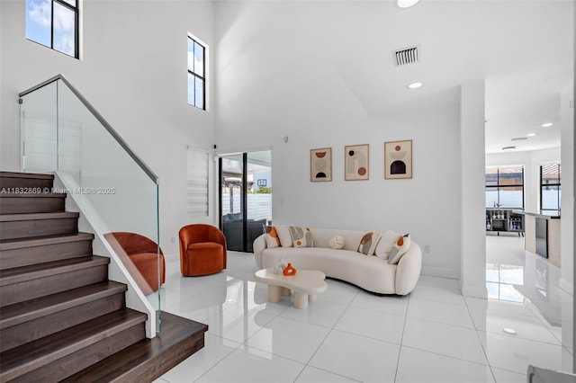 1005 NW 100th Ave, Miami, FL 33172 - living room featuring stairs, recessed lighting, light tile patterned flooring, and a towering ceiling