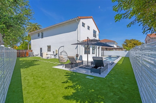 1005 NW 100th Ave, Miami, FL 33172 - rear view of house with stucco siding, a fenced backyard, and a patio