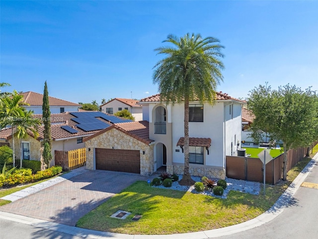 1005 NW 100th Ave, Miami, FL 33172 - mediterranean / spanish-style home featuring stone siding, an attached garage, driveway, and a tile roof