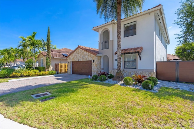 1005 NW 100th Ave, Miami, FL 33172 - mediterranean / spanish-style house featuring stone siding, stucco siding, driveway, and an attached garage