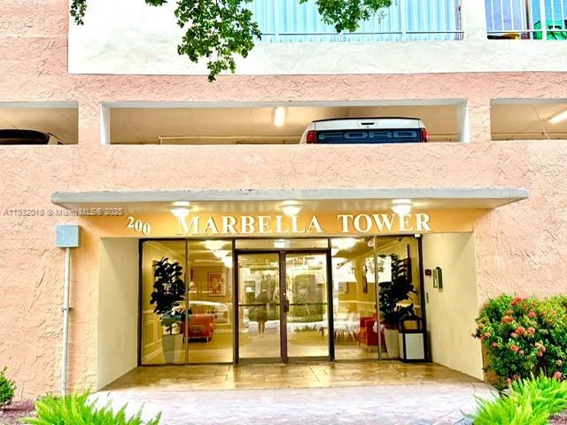 200 178th Dr Unit 409, Sunny Isles Beach, FL 33160 - property entrance with french doors and stucco siding