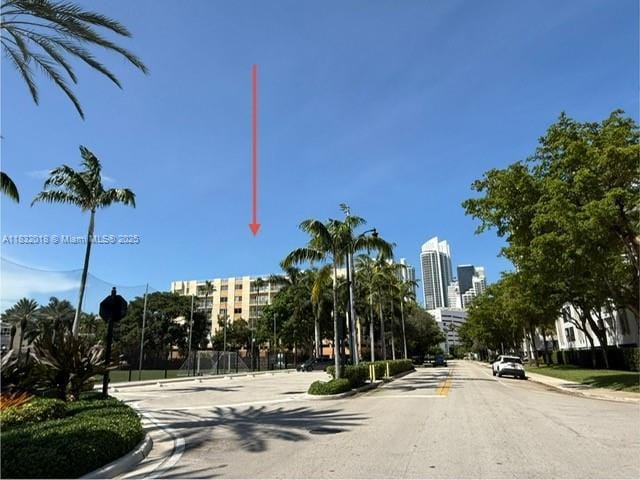 200 178th Dr Unit 409, Sunny Isles Beach, FL 33160 - view of asphalt street featuring a view of skyline, curbs, sidewalks, and street lights
