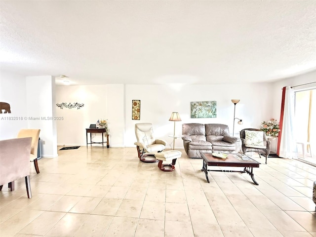 200 178th Dr Unit 409, Sunny Isles Beach, FL 33160 - living room featuring a textured ceiling and light tile patterned floors