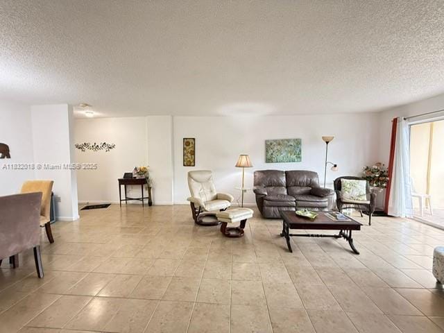 200 178th Dr Unit 409, Sunny Isles Beach, FL 33160 - living room featuring a textured ceiling and light tile patterned floors