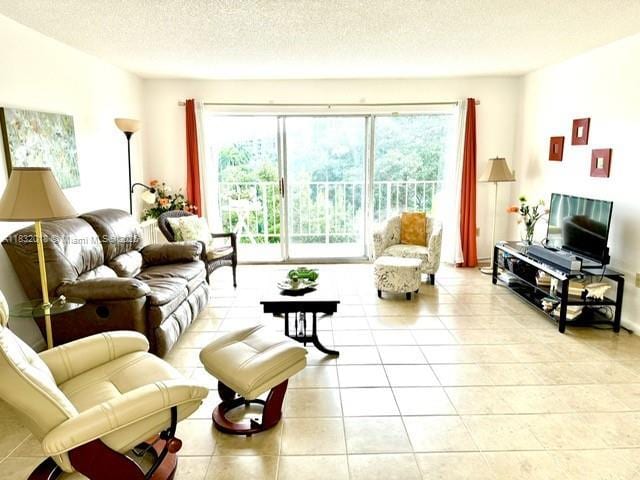 200 178th Dr Unit 409, Sunny Isles Beach, FL 33160 - living room featuring light tile patterned flooring and a textured ceiling