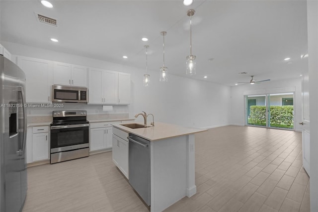 14549 Bretton Woods Trce, Delray Beach, FL 33446 - kitchen with stainless steel appliances, open floor plan, white cabinetry, light countertops, and recessed lighting