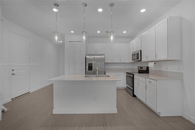 14549 Bretton Woods Trce, Delray Beach, FL 33446 - kitchen featuring appliances with stainless steel finishes, light countertops, white cabinetry, an island with sink, and recessed lighting