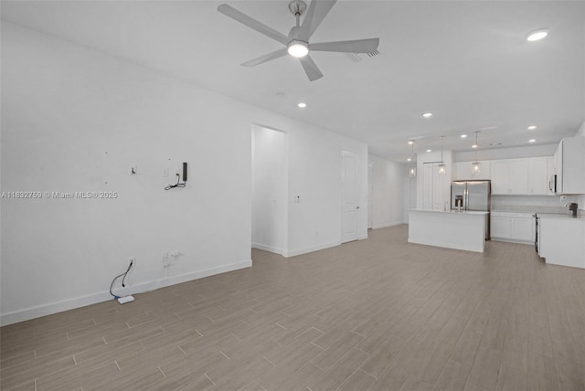 14549 Bretton Woods Trce, Delray Beach, FL 33446 - unfurnished living room featuring a ceiling fan, light wood-type flooring, and recessed lighting
