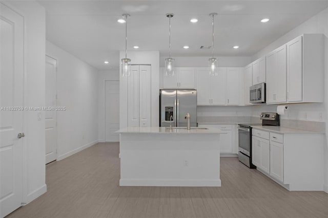 14549 Bretton Woods Trce, Delray Beach, FL 33446 - kitchen with appliances with stainless steel finishes, white cabinets, light countertops, an island with sink, and recessed lighting