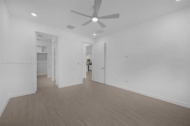 14549 Bretton Woods Trce, Delray Beach, FL 33446 - unfurnished bedroom featuring a walk in closet, wood finished floors, a ceiling fan, a closet, and recessed lighting