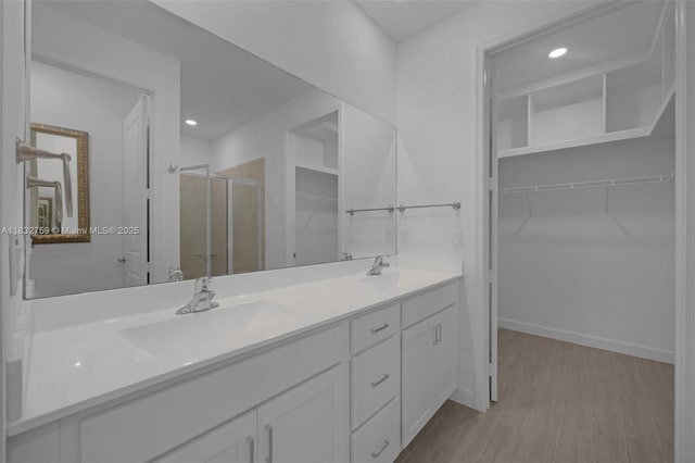 14549 Bretton Woods Trce, Delray Beach, FL 33446 - full bathroom with a stall shower, double vanity, a spacious closet, and recessed lighting
