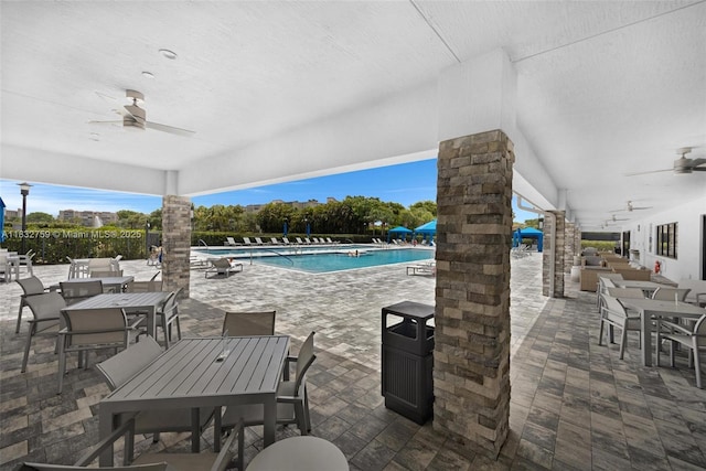 14549 Bretton Woods Trce, Delray Beach, FL 33446 - view of patio featuring outdoor dining area, ceiling fan, a community pool, and an outdoor living space