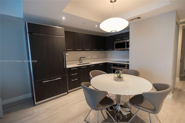 45 SW 9th St Unit 1705, Miami, FL 33130 - kitchen featuring a raised ceiling, appliances with stainless steel finishes, light countertops, light wood-style flooring, and modern cabinets