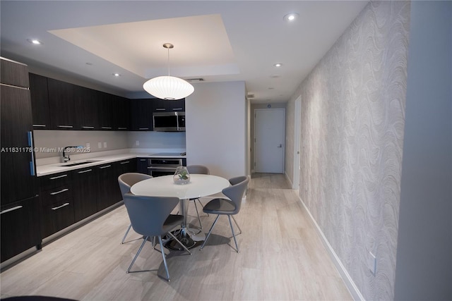 45 SW 9th St Unit 1705, Miami, FL 33130 - kitchen with stainless steel appliances, light wood-style floors, a raised ceiling, light countertops, and recessed lighting