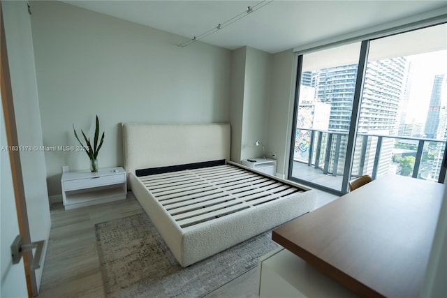 45 SW 9th St Unit 1705, Miami, FL 33130 - bedroom with a wall of windows and light wood-type flooring